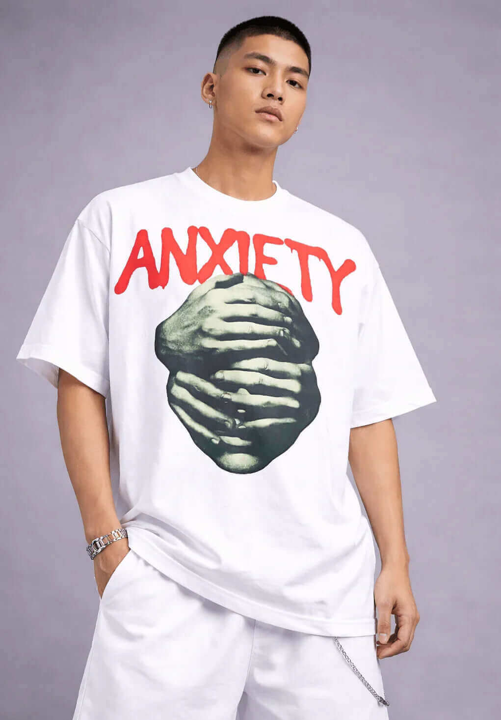 Oversized white graphic tee with red 'ANXIETY' text and grayscale hands art, streetwear style