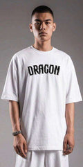Oversized white T-shirt with bold 'DRAGON' 3D shadow lettering, streetwear style