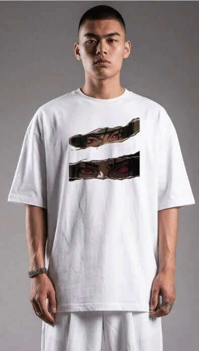 Man wearing oversized white graphic tee with mysterious anime eyes print, streetwear style